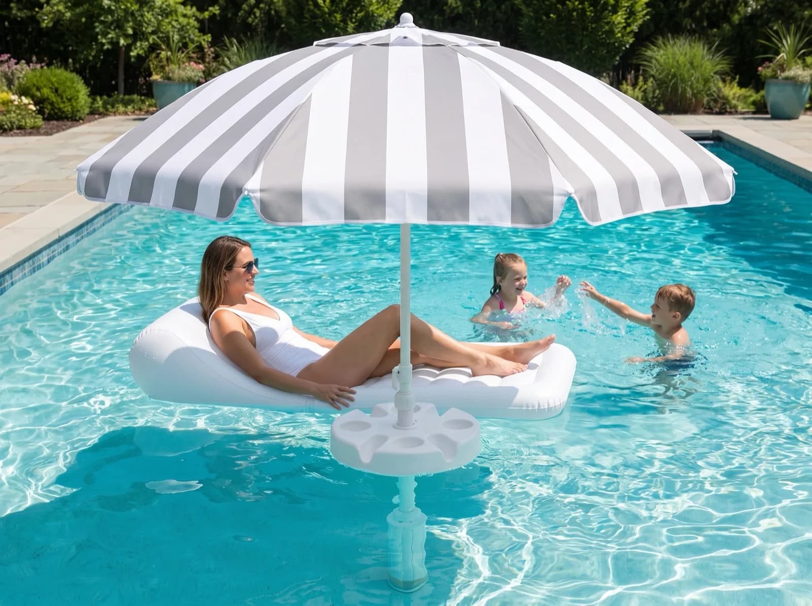 The FloatMate casting a circle of shade on the water while children swim in the sun beyond it